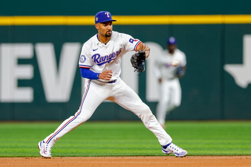 May 15, 2024; Arlington, Texas, USA; Texas Rangers second base Marcus Semien (2) fields a ground ball during the second inning against the Cleveland Guardians at Globe Life Field. Mandatory Credit: Andrew Dieb-USA TODAY Sports