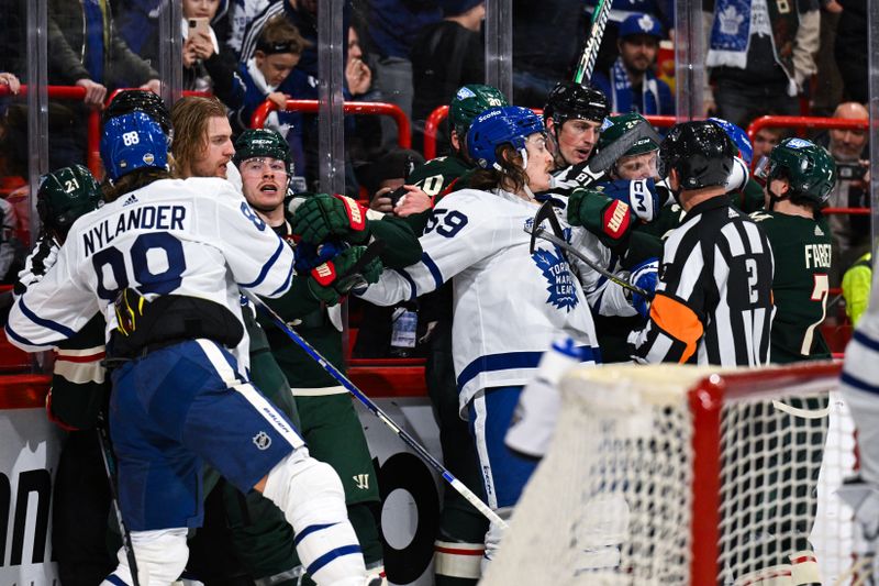 Nov 19, 2023; Stockholm, SWE; Toronto Maple Leafs and Minnesota Wild players are separated after a play during a Global Series NHL hockey game at Avicii Arena. Mandatory Credit: Per Haljestam-USA TODAY Sports