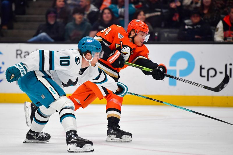 Dec 29, 2025; Anaheim, California, USA; Anaheim Ducks center Mikael Granlund (64) shoots against the defense of San Jose Sharks center Ty Dellandrea (10) during the second period at Honda Center. Mandatory Credit: Gary A. Vasquez-Imagn Images