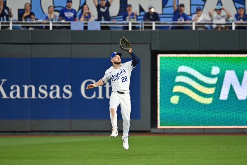 Oct 9, 2024; Kansas City, Missouri, USA; Kansas City Royals outfielder Kyle Isbel (28) leaps for the ball in the sixth inning against the New York Yankees during game three of the NLDS for the 2024 MLB Playoffs at Kauffman Stadium. Mandatory Credit: Peter Aiken-Imagn Images