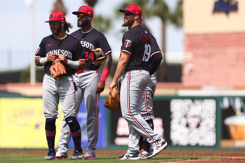 Mar 5, 2024; Jupiter, Florida, USA; Minnesota Twins second baseman Austin Martin (82), third baseman Niko Goodrum (24) and first baseman Alex Kirilloff (19) look on against the St. Louis Cardinals during the third inning at Roger Dean Chevrolet Stadium. Mandatory Credit: Sam Navarro-USA TODAY Sports