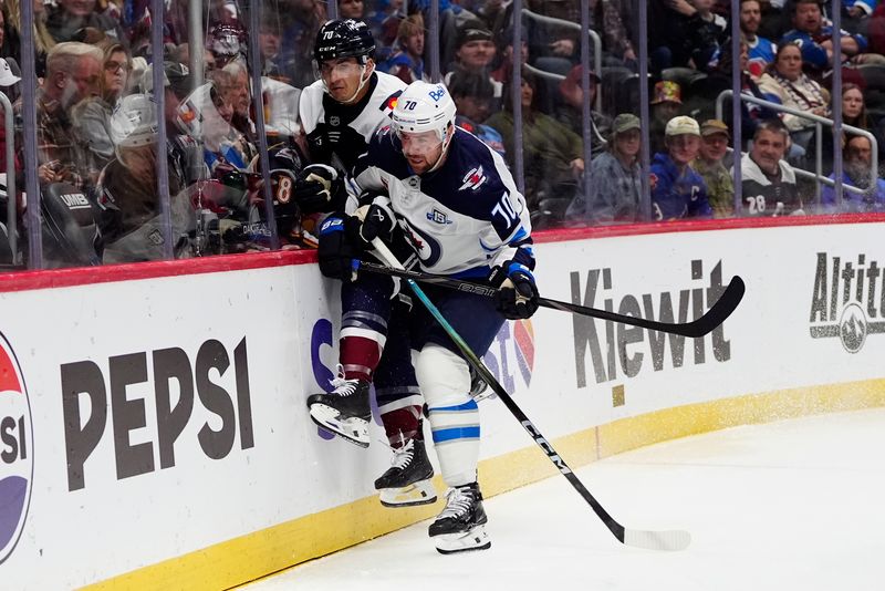 Dec 19, 2025; Denver, Colorado, USA; Winnipeg Jets left wing Tanner Pearson (70) checks Colorado Avalanche defenseman Sam Malinski (70) in the first period at Ball Arena. Mandatory Credit: Ron Chenoy-Imagn Images
