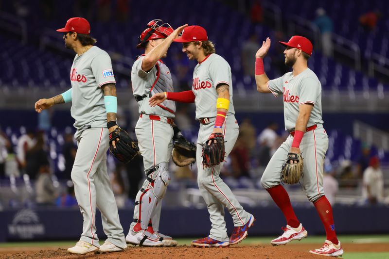 Sep 5, 2024; Miami, Florida, USA; Philadelphia Phillies second baseman Bryson Stott (5) celebrates with catcher J.T. Realmuto (10) and third baseman Kody Clemens (2) after the game against the Miami Marlins at loanDepot Park. Mandatory Credit: Sam Navarro-Imagn Images