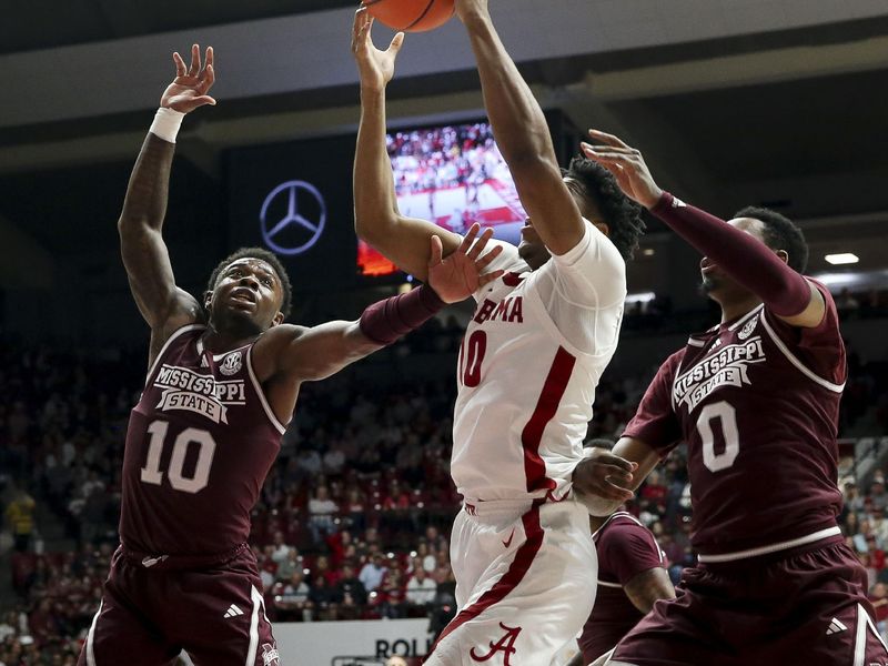 Feb 3, 2024; Tuscaloosa, Alabama, USA;  Alabama forward Mouhamed Dioubate (10) rebounds against Mississippi State guard Dashawn Davis (10) and Mississippi State forward D.J. Jeffries (0) at Coleman Coliseum. Mandatory Credit: Gary Cosby Jr.-USA TODAY Sports