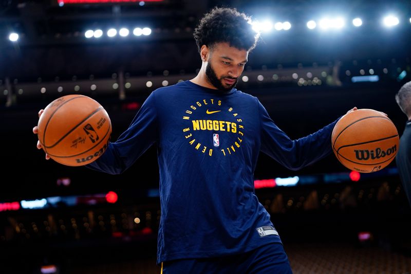 TORONTO, CANADA - OCTOBER 28: Jamal Murray #27 of the Denver Nuggets smiles during the warm up before the game against the Toronto Raptors on October 28, 2024 at the Scotiabank Arena in Toronto, Ontario, Canada.  NOTE TO USER: User expressly acknowledges and agrees that, by downloading and or using this Photograph, user is consenting to the terms and conditions of the Getty Images License Agreement.  Mandatory Copyright Notice: Copyright 2024 NBAE (Photo by Mark Blinch/NBAE via Getty Images)