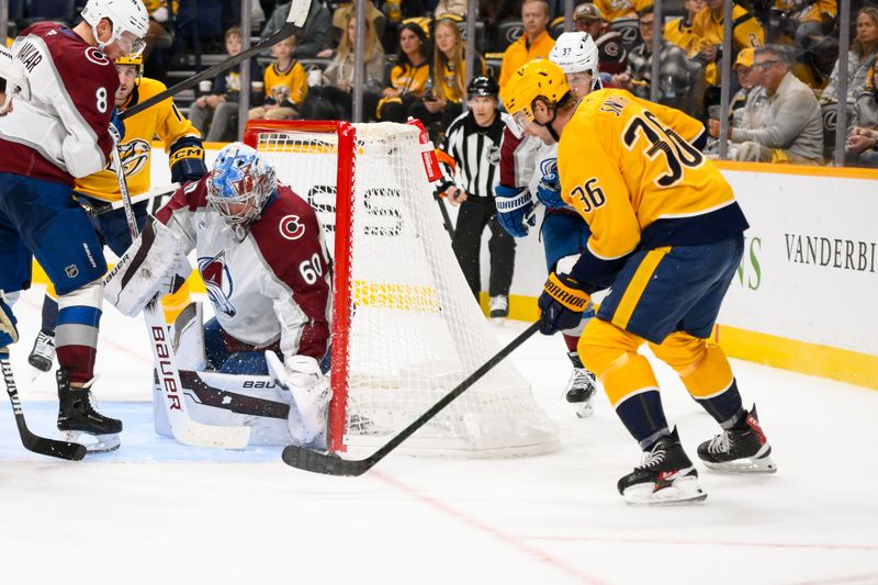 Nov 2, 2024; Nashville, Tennessee, USA;  Colorado Avalanche goaltender Justus Annunen (60) blocks the shot of Nashville Predators left wing Cole Smith (36) during the third period at Bridgestone Arena. Mandatory Credit: Steve Roberts-Imagn Images