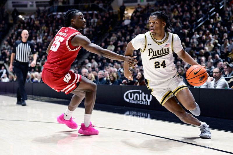 Feb 15, 2025; West Lafayette, Indiana, USA; Purdue Boilermakers guard Gicarri Harris (24) drives the ball around Wisconsin Badgers guard John Blackwell (25) during the second half at Mackey Arena. Mandatory Credit: Marc Lebryk-Imagn Images