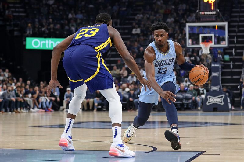 MEMPHIS, TENNESSEE - FEBRUARY 02: Jaren Jackson Jr. #13 of the Memphis Grizzlies handles the ball against Draymond Green #23 of the Golden State Warriors during the first half at FedExForum on February 02, 2024 in Memphis, Tennessee. NOTE TO USER: User expressly acknowledges and agrees that, by downloading and or using this photograph, User is consenting to the terms and conditions of the Getty Images License Agreement. (Photo by Justin Ford/Getty Images)