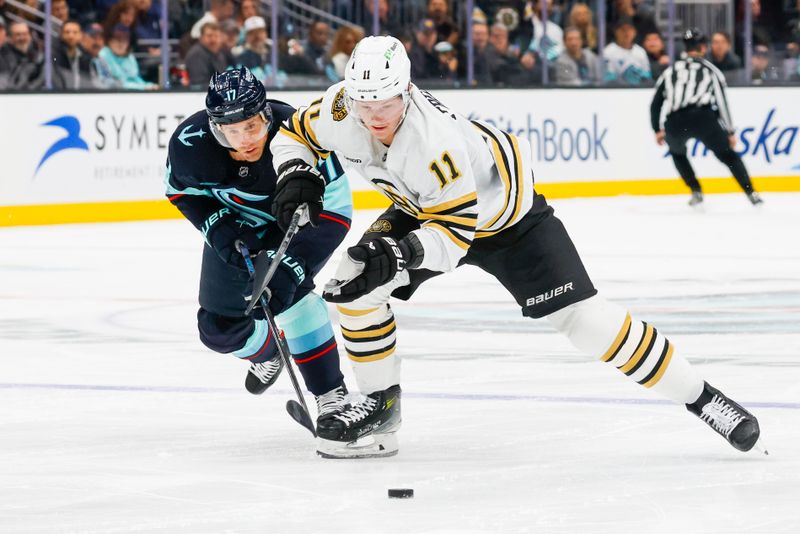 Feb 26, 2024; Seattle, Washington, USA; Boston Bruins center Trent Frederic (11) chases down the puck ahead of Seattle Kraken center Jaden Schwartz (17) during the second period at Climate Pledge Arena. Mandatory Credit: Joe Nicholson-USA TODAY Sports