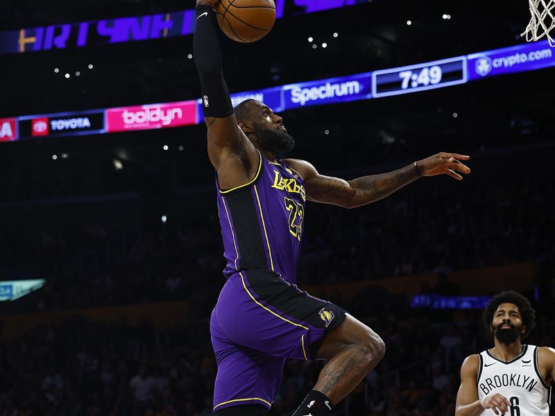 LOS ANGELES, CALIFORNIA - JANUARY 19:  LeBron James #23 of the Los Angeles Lakers makes a slam dunk against the Brooklyn Nets in the first half at Crypto.com Arena on January 19, 2024 in Los Angeles, California.  NOTE TO USER: User expressly acknowledges and agrees that, by downloading and/or using this photograph, user is consenting to the terms and conditions of the Getty Images License Agreement.  (Photo by Ronald Martinez/Getty Images)