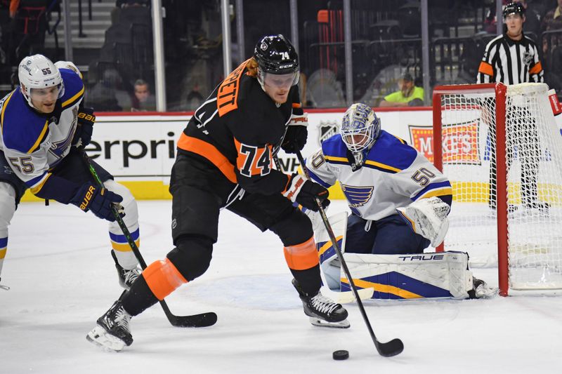 Oct 31, 2024; Philadelphia, Pennsylvania, USA; Philadelphia Flyers right wing Owen Tippett (74) controls the puck against St. Louis Blues defenseman Colton Parayko (55) and goaltender Jordan Binnington (50) during the first period at Wells Fargo Center. Mandatory Credit: Eric Hartline-Imagn Images