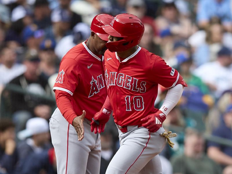 Sep 14, 2025; Seattle, Washington, USA; Los Angeles Angels third base Oswald Peraza (10) is greeted by Los Angeles Angels third base coach Bo Porter (88) after hitting a solo home run against the Seattle Mariners during the sixth inning at T-Mobile Park. Mandatory Credit: John Froschauer-Imagn Images