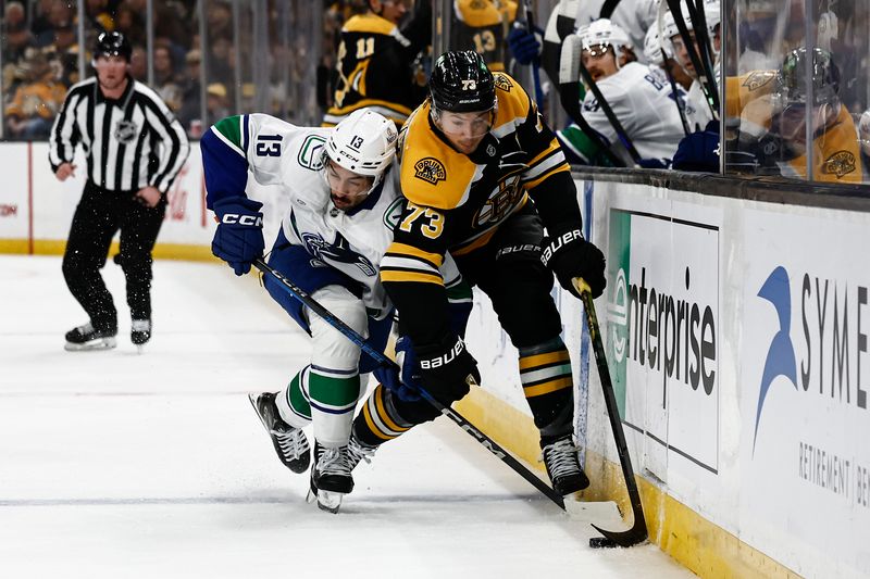 Nov 26, 2024; Boston, Massachusetts, USA; Vancouver Canucks left wing Arshdeep Bains (13) tries to cut off Boston Bruins defenseman Charlie McAvoy (73) during the first period at TD Garden. Mandatory Credit: Winslow Townson-Imagn Images