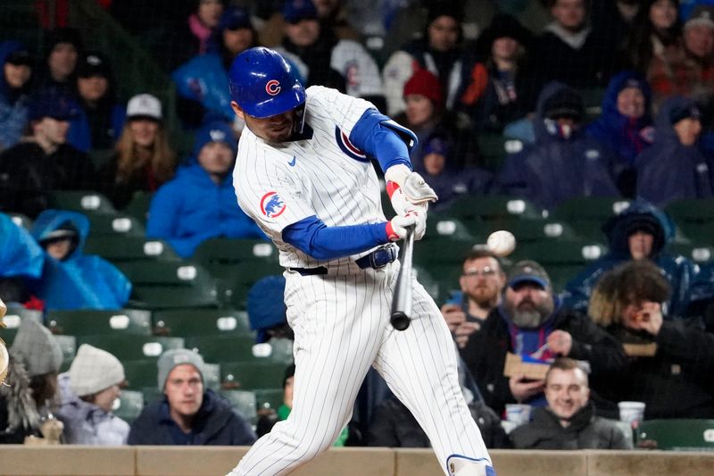 Apr 3, 2024; Chicago, Illinois, USA; Chicago Cubs right fielder Seiya Suzuki (27) hits a two-run single against the Colorado Rockies during the second inning at Wrigley Field. Mandatory Credit: David Banks-USA TODAY Sports