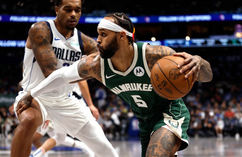 DALLAS, TX -OCTOBER 17: Gary Trent Jr. #5 of the Milwaukee Bucks drives toward the basket as P.J. Washington #25 of the Dallas Mavericks defends in the first half of an NBA preseason game at American Airlines Center on October 17, 2024 in Dallas, Texas. NOTE TO USER: User expressly acknowledges and agrees that, by downloading and or using this photograph, User is consenting to the terms and conditions of the Getty Images License Agreement. (Photo by Ron Jenkins/Getty Images)