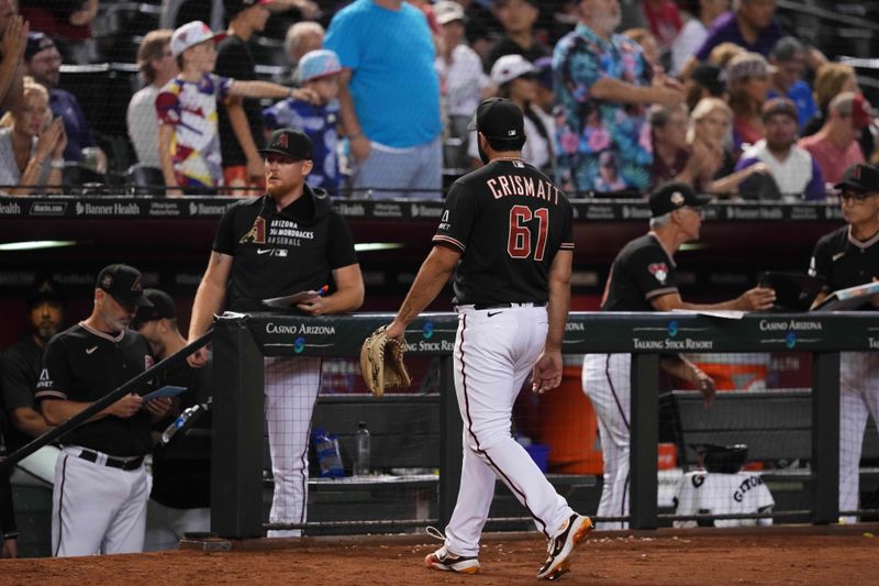 Aug 26, 2023; Phoenix, Arizona, USA; Arizona Diamondbacks relief pitcher Nabil Crismatt (61) walks back to the dugout during the 11th inning against the Cincinnati Reds at Chase Field. Mandatory Credit: Joe Camporeale-USA TODAY Sports