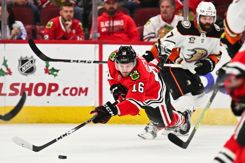 Dec 7, 2023; Chicago, Illinois, USA; Chicago Blackhawks forward Jason Dickinson (16) is tripped up by Anaheim Ducks defenseman Radko Gudas (7) in the first period at United Center. Mandatory Credit: Jamie Sabau-USA TODAY Sports