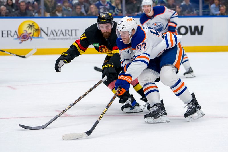 Nov 9, 2024; Vancouver, British Columbia, CAN; Edmonton Oilers forward Connor McDavid (97) drives past Vancouver Canucks defenseman Filip Hronek (17) during the first period at Rogers Arena. Mandatory Credit: Bob Frid-Imagn Images