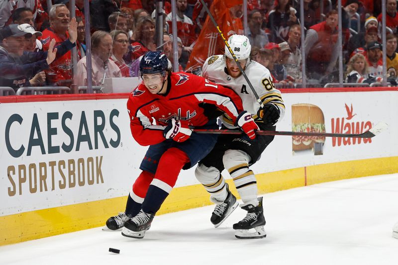 Apr 15, 2024; Washington, District of Columbia, USA; Washington Capitals center Dylan Strome (17) and Boston Bruins right wing David Pastrnak (88) battle for the puck in the third period at Capital One Arena. Mandatory Credit: Geoff Burke-USA TODAY Sports