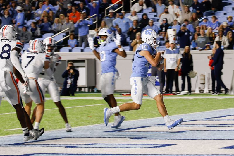 Oct 21, 2023; Chapel Hill, North Carolina, USA; North Carolina Tar Heels quarterback Drake Maye (10) runs for a touchdown against the Virginia Cavaliers in the second half at Kenan Memorial Stadium. Mandatory Credit: Nell Redmond-USA TODAY Sports