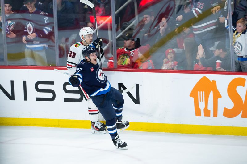 Jan 11, 2024; Winnipeg, Manitoba, CAN; Winnipeg Jets forward Nikolaj Ehlers (27) celebrates his goal against Chicago Blackhawks goalie Petr Mrazek (34) during the third period at Canada Life Centre. Mandatory Credit: Terrence Lee-USA TODAY Sports