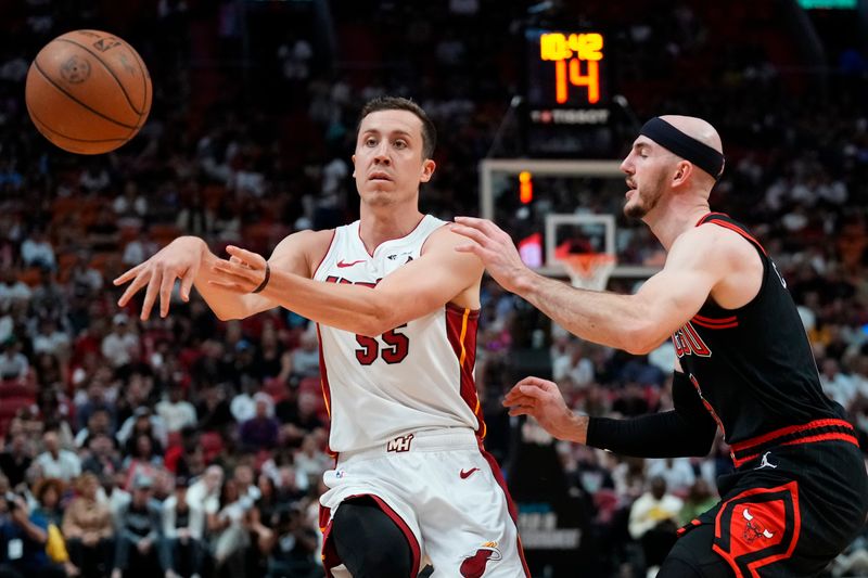 MIAMI, FLORIDA - APRIL 19: Duncan Robinson #55 of the Miami Heat throws a pass against Alex Caruso #6 of the Chicago Bulls in the second quarter during the Play-In Tournament at Kaseya Center on April 19, 2024 in Miami, Florida. NOTE TO USER: User expressly acknowledges and agrees that, by downloading and or using this photograph, User is consenting to the terms and conditions of the Getty Images License Agreement. (Photo by Rich Storry/Getty Images)