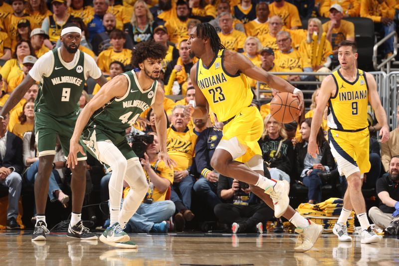 INDIANAPOLIS, IN - APRIL 26: Aaron Nesmith #23 of the Indiana Pacers dribbles the ball during the game against the Milwaukee Bucks during Round 1 Game 3 of the 2024 NBA Playoffs on April 26, 2024 at Gainbridge Fieldhouse in Indianapolis, Indiana. NOTE TO USER: User expressly acknowledges and agrees that, by downloading and or using this Photograph, user is consenting to the terms and conditions of the Getty Images License Agreement. Mandatory Copyright Notice: Copyright 2023 NBAE (Photo by Nathaniel S. Butler/NBAE via Getty Images)