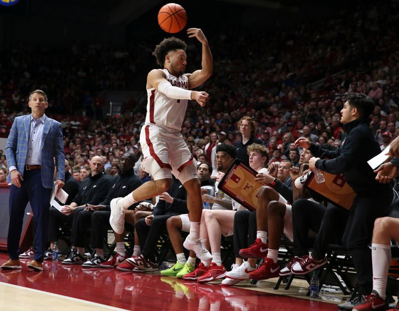 Feb 3, 2024; Tuscaloosa, Alabama, USA;  Alabama guard Mark Sears (1) leaps in front of the Alabama bench to keep a ball inbound at Coleman Coliseum. Mandatory Credit: Gary Cosby Jr.-USA TODAY Sports