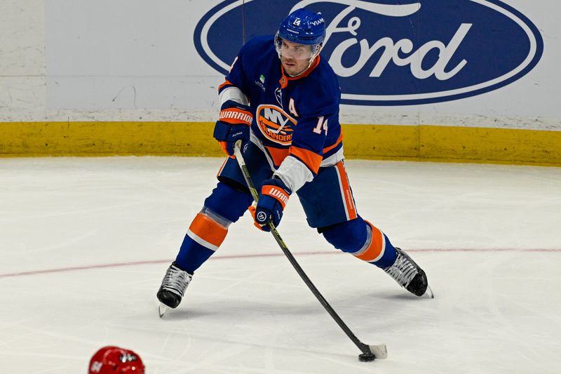 Apr 14, 2026; Elmont, New York, USA; New York Islanders center Bo Horvat (14) attempts a shot against the Carolina Hurricanes during the second period at UBS Arena. Mandatory Credit: Dennis Schneidler-Imagn Images Apr 14, 2026; Elmont, New York, USA; New York Islanders center Bo Horvat (14) attempts a shot against the Carolina Hurricanes during the second period at UBS Arena. Mandatory Credit: Dennis Schneidler-Imagn Images