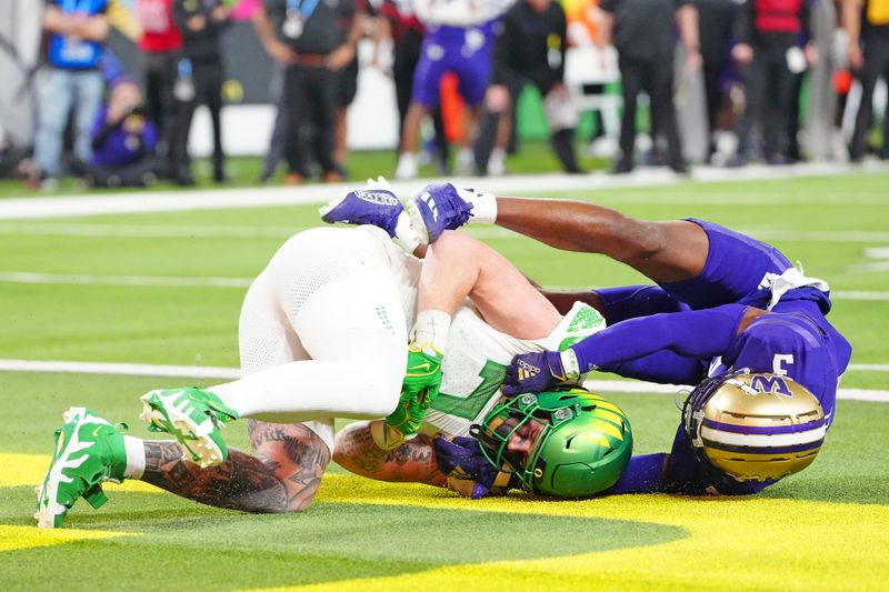 Dec 1, 2023; Las Vegas, NV, USA; Oregon Ducks tight end Terrance Ferguson (3) catches a touchdown against Washington Huskies safety Mishael Powell (3) during the third quarter at Allegiant Stadium. Mandatory Credit: Stephen R. Sylvanie-USA TODAY Sports