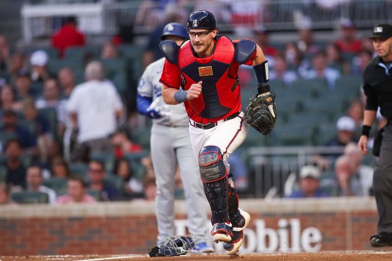 May 2, 2025; Atlanta, Georgia, USA; Atlanta Braves catcher Sean Murphy (12) runs to the ball against the Los Angeles Dodgers in the fourth inning at Truist Park. Mandatory Credit: Brett Davis-Imagn Images