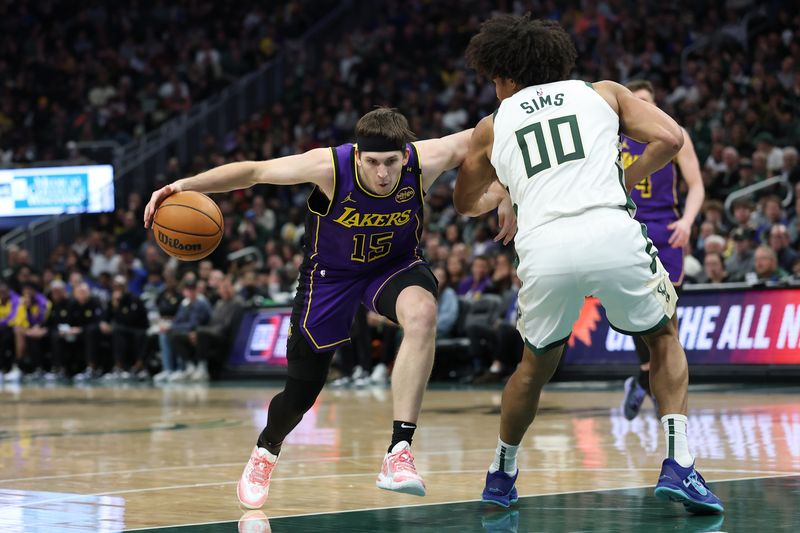 MILWAUKEE, WISCONSIN - MARCH 13: Austin Reaves #15 of the Los Angeles Lakers drives around Jericho Sims #00 of the Milwaukee Bucks during a game at Fiserv Forum on March 13, 2025 in Milwaukee, Wisconsin. NOTE TO USER: User expressly acknowledges and agrees that, by downloading and or using this photograph, User is consenting to the terms and conditions of the Getty Images License Agreement. (Photo by Stacy Revere/Getty Images)