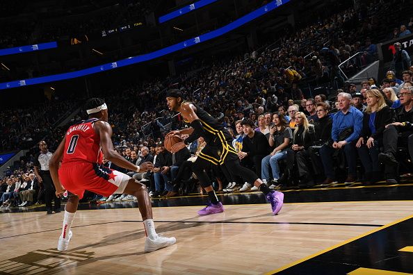 SAN FRANCISCO, CA - DECEMBER 22: Moses Moody #4 of the Golden State Warriors dribbles the ball during the game against the Washington Wizards on December 22, 2023 at Chase Center in San Francisco, California. NOTE TO USER: User expressly acknowledges and agrees that, by downloading and or using this photograph, user is consenting to the terms and conditions of Getty Images License Agreement. Mandatory Copyright Notice: Copyright 2023 NBAE (Photo by Noah Graham/NBAE via Getty Images)