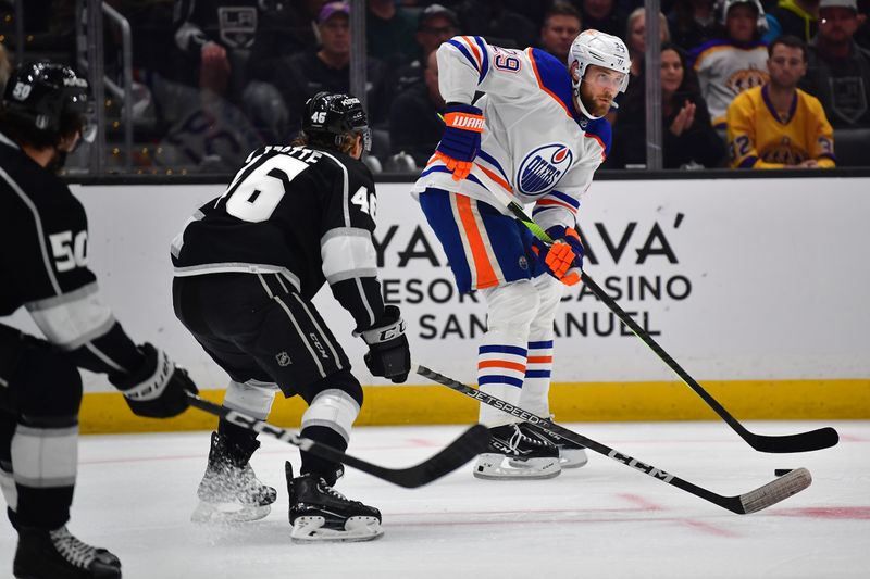 Apr 29, 2023; Los Angeles, California, USA; Edmonton Oilers center Leon Draisaitl (29) controls the puck against Los Angeles Kings center Blake Lizotte (46) during the first period in game six of the first round of the 2023 Stanley Cup Playoffs at Crypto.com Arena. Mandatory Credit: Gary A. Vasquez-USA TODAY Sports