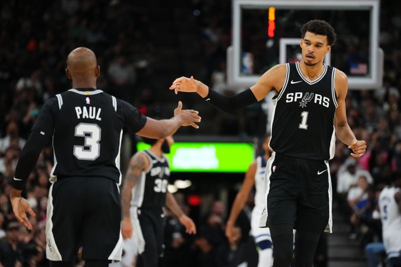 SAN ANTONIO, TX - NOVEMBER 2: Chris Paul #3 and Victor Wembanyama #1 of the San Antonio Spurs high five during the game against the Minnesota Timberwolves on November 2, 2024 at the Frost Bank Center in San Antonio, Texas. NOTE TO USER: User expressly acknowledges and agrees that, by downloading and or using this photograph, user is consenting to the terms and conditions of the Getty Images License Agreement. Mandatory Copyright Notice: Copyright 2024 NBAE (Photos by Cooper Neill/NBAE via Getty Images)