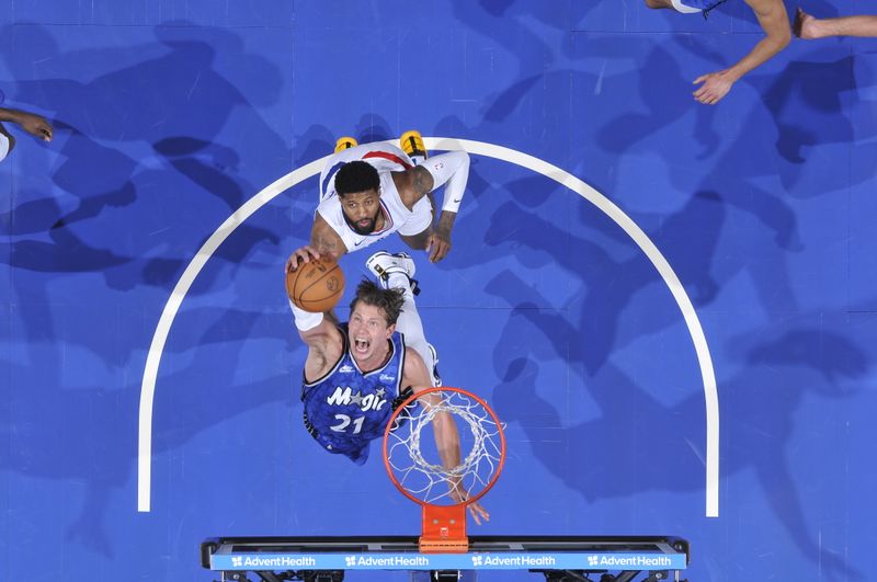 ORLANDO, FL - MARCH 29: Moritz Wagner #21 of the Orlando Magic grabs a rebound during the game against the LA Clippers on March 29, 2024 at the Kia Center in Orlando, Florida. NOTE TO USER: User expressly acknowledges and agrees that, by downloading and or using this photograph, User is consenting to the terms and conditions of the Getty Images License Agreement. Mandatory Copyright Notice: Copyright 2024 NBAE (Photo by Fernando Medina/NBAE via Getty Images)