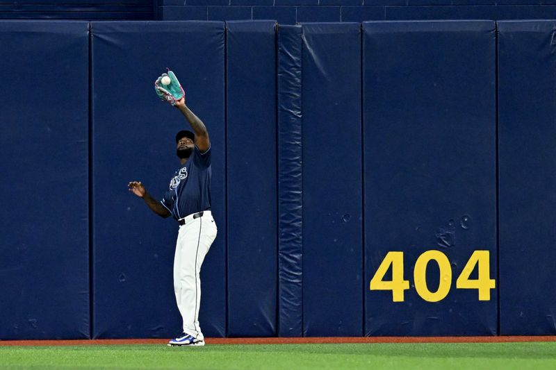 Apr 23, 2024; St. Petersburg, Florida, USA; Tampa Bay Rays center fielder fielder Randy Arozarena (56) catches a fly ball in the third inning against the Detroit Tigers at Tropicana Field. Mandatory Credit: Jonathan Dyer-USA TODAY Sports