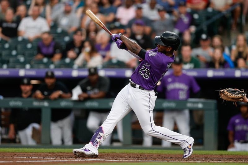 Aug 18, 2023; Denver, Colorado, USA; Colorado Rockies designated hitter Jurickson Profar (29) hits a double in the fourth inning against the Chicago White Sox at Coors Field. Mandatory Credit: Isaiah J. Downing-USA TODAY Sports