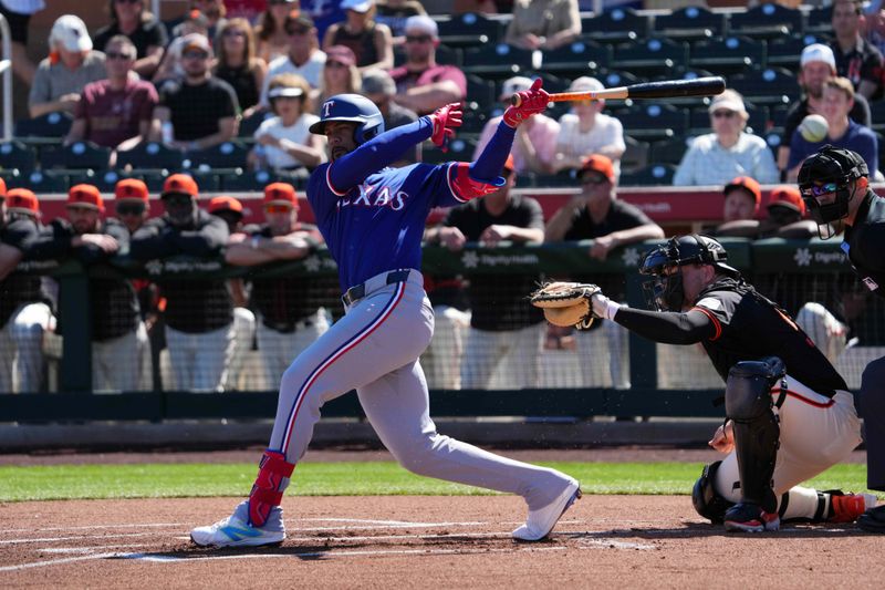 Mar 1, 2024; Scottsdale, Arizona, USA; Texas Rangers center fielder Leody Taveras (3) bats against the San Francisco Giants during the first inning at Scottsdale Stadium. Mandatory Credit: Joe Camporeale-USA TODAY Sports