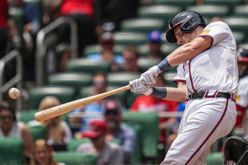 Jun 19, 2024; Cumberland, Georgia, USA; Atlanta Braves catcher Sean Murphy (12) hits a single against the Detroit Tigers during the seventh inning at Truist Park. Mandatory Credit: Dale Zanine-USA TODAY Sports