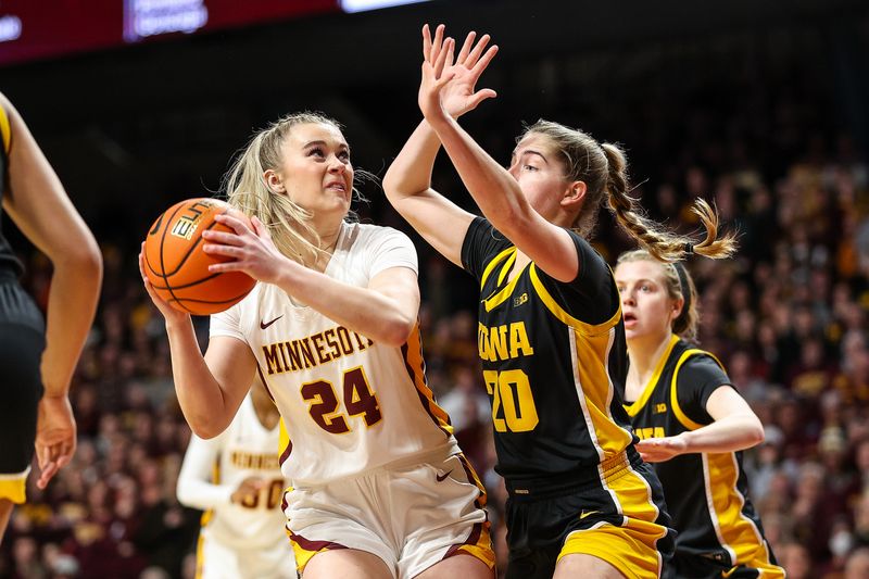 Feb 28, 2024; Minneapolis, Minnesota, USA; Minnesota Golden Gophers forward Mallory Heyer (24) shoots as Iowa Hawkeyes guard Kate Martin (20) defends during the first half at Williams Arena. Mandatory Credit: Matt Krohn-USA TODAY Sports