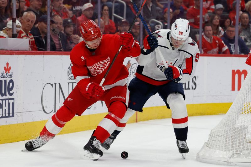 Apr 9, 2024; Detroit, Michigan, USA;  Detroit Red Wings defenseman Olli Maatta (2) and Washington Capitals right wing Nicolas Aube-Kubel (96)ref10 battle for the puck in the second period at Little Caesars Arena. Mandatory Credit: Rick Osentoski-USA TODAY Sports