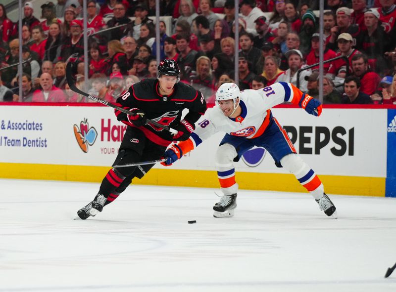 Apr 22, 2024; Raleigh, North Carolina, USA; Carolina Hurricanes center Martin Necas (88) skates inside New York Islanders left wing Pierre Engvall (18) during the first period in game two of the first round of the 2024 Stanley Cup Playoffs at PNC Arena. Mandatory Credit: James Guillory-USA TODAY Sports