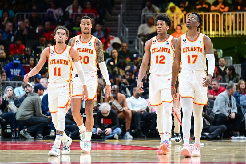 ATLANTA, GA - FEBUARY 9: Trae Young #11;John Collins #20, De'Andre Hunter #12 and Onyeka Okongwu #17 of the Atlanta Hawks looks on during the game  on Febuary 9, 2023 at State Farm Arena in Atlanta, Georgia.  NOTE TO USER: User expressly acknowledges and agrees that, by downloading and/or using this Photograph, user is consenting to the terms and conditions of the Getty Images License Agreement. Mandatory Copyright Notice: Copyright 2023 NBAE (Photo by Adam Hagy/NBAE via Getty Images)