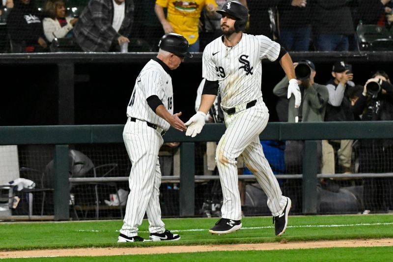 eMay 10, 2024; Chicago, Illinois, USA;  Chicago White Sox shortstop Paul DeJong (29) high fives third base coach Eddie Rodriguez (18) after hitting a home run against the Cleveland Guardians during the seventh inning at Guaranteed Rate Field. Mandatory Credit: Matt Marton-USA TODAY Sports