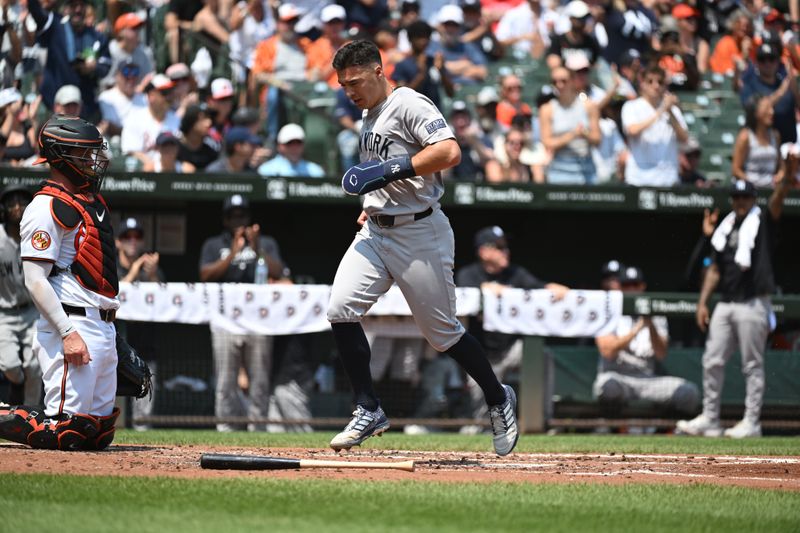 Jul 14, 2024; Baltimore, Maryland, USA;  New York Yankees shortstop Anthony Volpe (11) scores on a single by New York Yankees outfielder Trent Grisham (not pictured) during the second inning against the Baltimore Orioles at Oriole Park at Camden Yards. Mandatory Credit: James A. Pittman-USA TODAY Sports