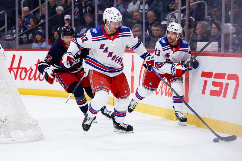 Mar 12, 2026; Winnipeg, Manitoba, CAN; New York Rangers forward Noah Laba (42) skates away from Winnipeg Jets forward Gabriel Vilardi (13) during the first period at Canada Life Centre. Mandatory Credit: Terrence Lee-Imagn Images
