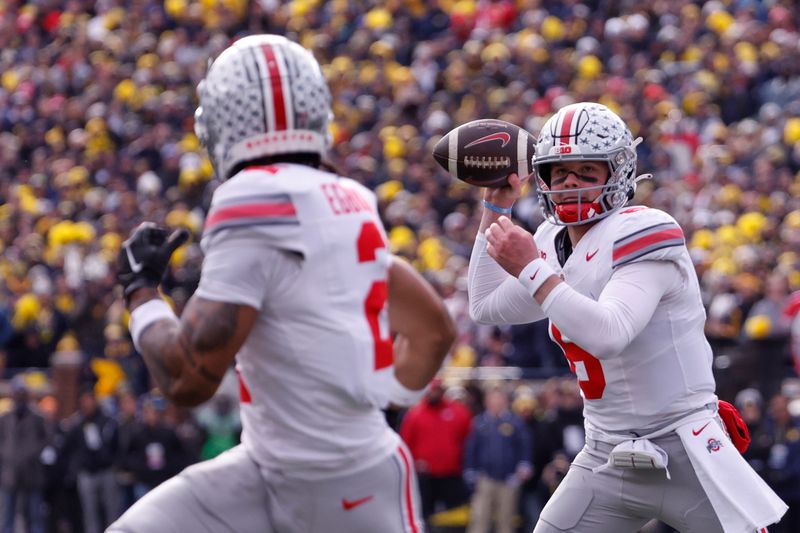 Nov 25, 2023; Ann Arbor, Michigan, USA; Ohio State Buckeyes quarterback Kyle McCord (6) passes to Ohio State Buckeyes wide receiver Emeka Egbuka (2) for a touchdown in the first half against the Michigan Wolverines at Michigan Stadium. Mandatory Credit: Rick Osentoski-USA TODAY Sports