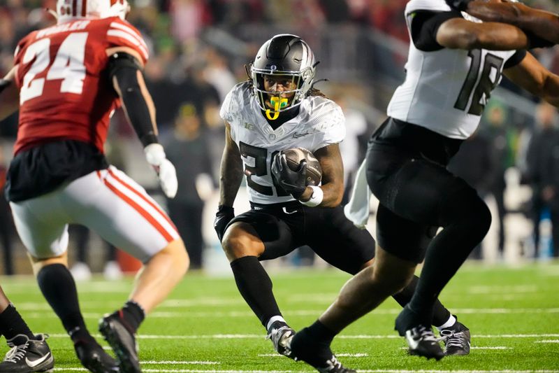 Nov 16, 2024; Madison, Wisconsin, USA;  Oregon Ducks running back Jordan James (20) rushes with the football during the fourth quarter against the Wisconsin Badgers at Camp Randall Stadium. Mandatory Credit: Jeff Hanisch-Imagn Images