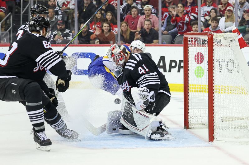 Oct 27, 2023; Newark, New Jersey, USA; New Jersey Devils goaltender Vitek Vanecek (41) makes a save in front of defenseman Kevin Bahl (88) during the second period against the Buffalo Sabres at Prudential Center. Mandatory Credit: Vincent Carchietta-USA TODAY Sports